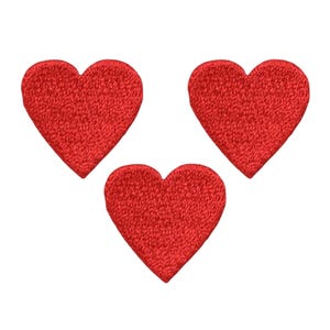 May include: Three red felt heart-shaped patches.