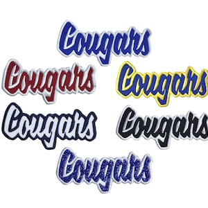 May include: Six embroidered patches with the word "Cougar" in different colors. The patches are white, red, yellow, blue, black, and silver.