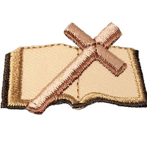 May include: Embroidered patch featuring a brown cross over a beige open book. The cross and book are outlined in brown thread.