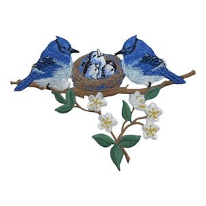 May include: Embroidered patch featuring two bluebirds perched on a branch with white blossoms. The birds are near a nest with three baby birds inside.
