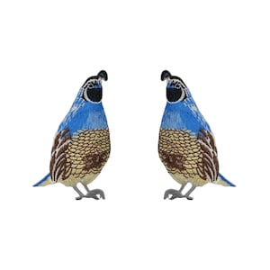 May include: Two blue and brown embroidered quail bird patches. The birds are facing opposite directions.