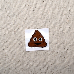 May include: A brown poop emoji with a white smiling face and two white eyes. The emoji is on a white background.