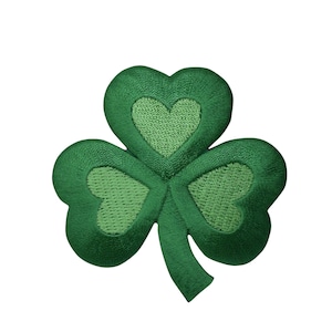May include: A green felt shamrock patch with three leaves, each with a smaller heart-shaped leaf inside.