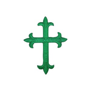 May include: A green embroidered cross with a decorative design. The cross is a religious symbol.