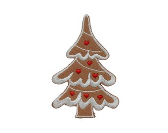 May include: A brown embroidered Christmas tree patch with white frosting-like trim and small red heart accents. The tree is a festive holiday decoration, perfect for adding to clothing or accessories.