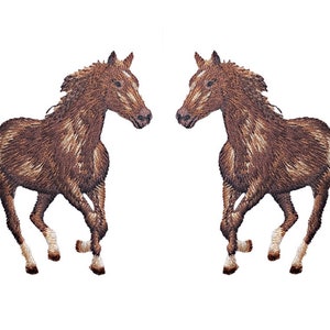 May include: Two embroidered brown horses in a running pose are depicted against a white background. The horses have detailed manes and tails, with white markings on their faces and legs. The image is a symmetrical design.