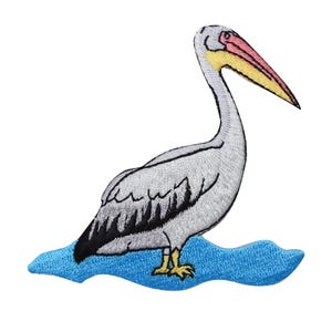 May include: Embroidered iron-on patch of a gray pelican with a pink and yellow beak standing on a blue wave.