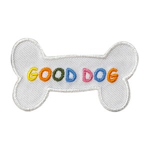 May include: White fabric bone-shaped patch with the words "GOOD DOG" embroidered in colorful letters.