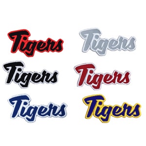 May include: Six embroidered iron-on patches with the word "Tigers" in different colors: red, black, white, blue, and yellow.