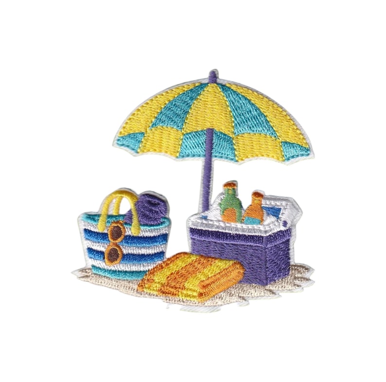 May include: Embroidered patch featuring a beach scene with a yellow and blue striped umbrella, a striped tote bag with sunglasses, a cooler with bottles, and a striped towel. The patch is on a sandy background.