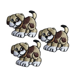 May include: Three embroidered iron-on patches of brown and white puppies with brown spots. The puppies are facing forward with their tongues sticking out.