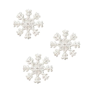 May include: Three silver snowflake embellishments, each with a delicate, intricate design.