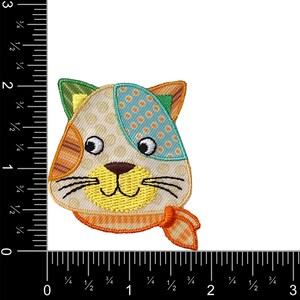 May include: A colorful patchwork cat face applique with a yellow smile, orange and white striped ears, and a blue and white polka dot patch on the head. The cat is wearing a bright orange scarf.