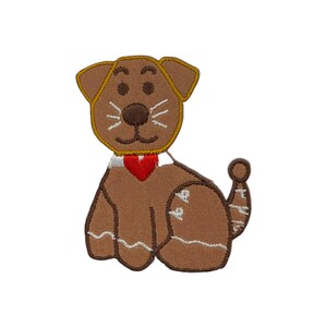 May include: A brown dog-shaped embroidered patch with a red heart collar. The patch features a light brown outline and details, including a tail, ears, and whiskers. The dog is sitting, and the patch is on a white background.