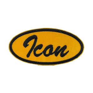 May include: Oval-shaped yellow patch with the word "Icon" embroidered in black script. The patch has a black border and is set against a white background. The patch is likely for clothing or accessories.