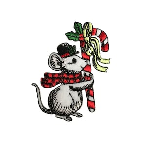 May include: A white mouse wearing a red and black plaid scarf and a black top hat holds a red and white candy cane with green holly and a yellow bow.