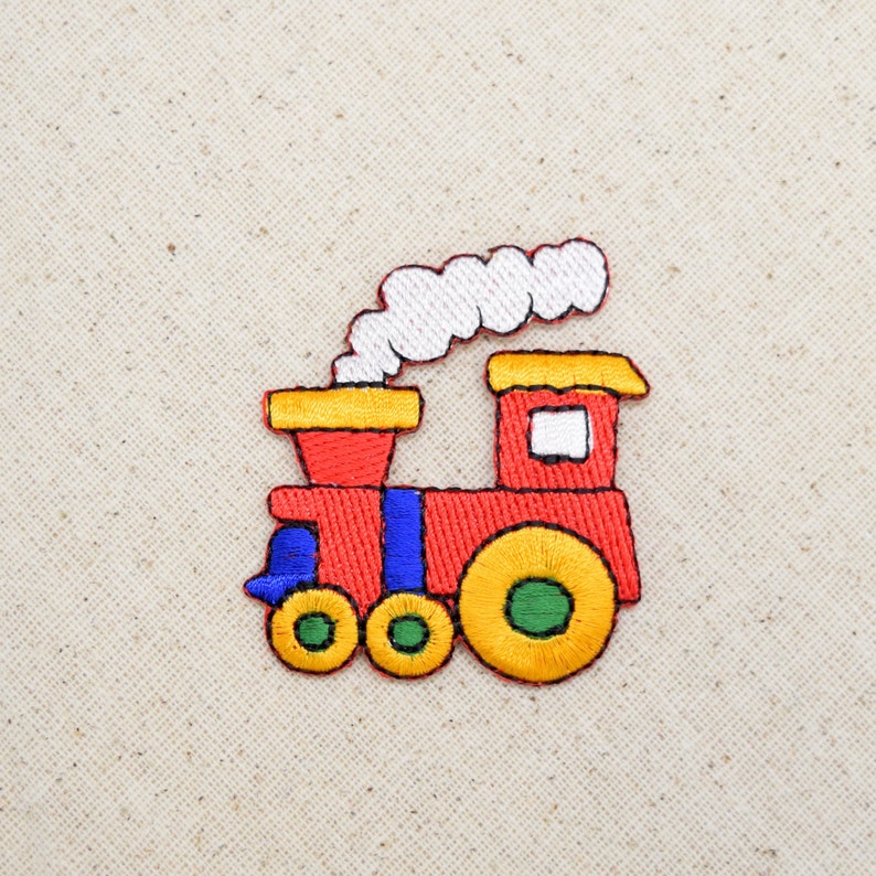 May include: A red, yellow, and blue embroidered train with a white smoke plume. The train has three wheels and a small window.