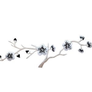May include: White embroidered cherry blossom branch with black centers. The branch is silver and has five blossoms.