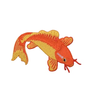 May include: An embroidered iron-on patch of a bright orange and yellow koi fish with a white stripe on its side. The fish is swimming to the right and has a slightly open mouth.