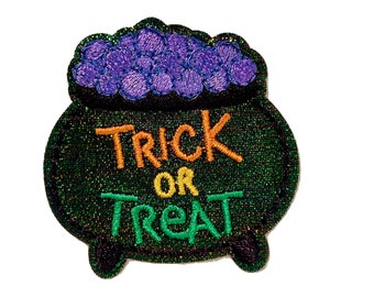 May include: Green cauldron with purple candy and the text "Trick or Treat" in orange and green embroidery.