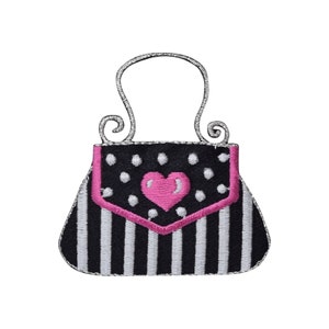 May include: Black and white striped handbag with a pink heart on the front flap. The handbag has a silver handle.