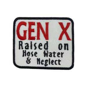 Puede incluir: Parche bordado con fondo blanco y borde negro. El parche presenta el texto "GEN X" en rojo, sobre el texto "Raised on Hose Water & Neglect" en negro, en forma rectangular.
