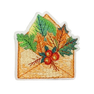 May include: Embroidered patch featuring a brown envelope with a floral design. The design includes green leaves, orange and brown fall leaves, and red berries.