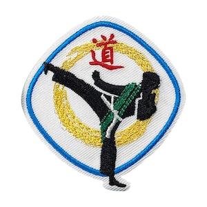 May include: An embroidered patch with a white background, a blue border, and a gold circle with a black silhouette of a person kicking. The word "道" is written in red in the center of the circle.