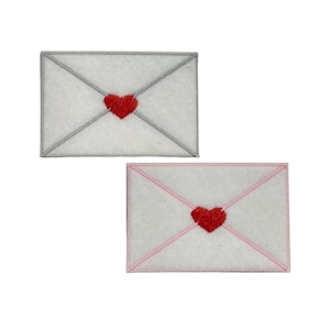 May include: Two embroidered felt patches shaped like envelopes with a red heart in the center. One envelope has a gray border and the other has a pink border.