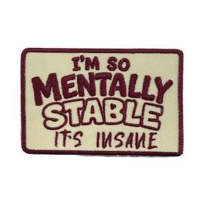 May include: A rectangular patch with a cream-colored background and a maroon border. The patch features the text "I'M SO MENTALLY STABLE ITS INSANE" in maroon, stylized lettering. The patch is likely for clothing or accessories.