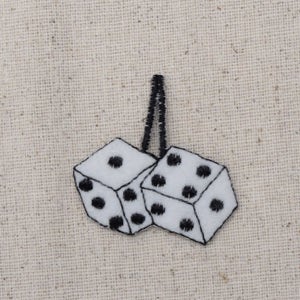 May include: Two white dice with black dots, sewn together, hanging from a black string. The dice are a popular car accessory.