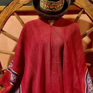 May include: A set of three ceramic mugs with a speckled, cream-colored glaze. Each mug features a different hand-painted floral design in shades of blue, green, and yellow. The mugs have a simple, rounded shape and a comfortable handle.