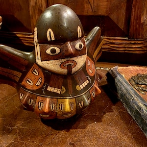 May include: A handmade wooden sign with the text "Welcome to our home" in a handwritten style. The sign is painted white with a distressed finish and a dark brown border. A small, decorative heart is attached to the bottom.