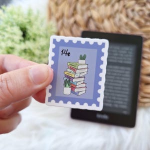 May include: A blue and white sticker with a stack of books and a potted plant. The sticker has a stamp design with the text "14¢" in the top left corner.