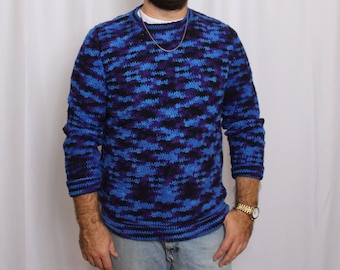 May include: A blue and black patterned crocheted sweater with long sleeves.