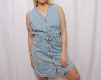 May include: A light blue denim dress with a button-up front and a sleeveless design.