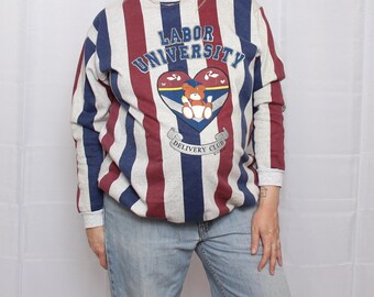 May include: A long-sleeve crewneck sweatshirt featuring vertical stripes in heather gray, navy blue, and maroon. The center graphic displays the text "LABOR UNIVERSITY" above a heart containing a teddy bear and the text "DELIVERY CLUB".