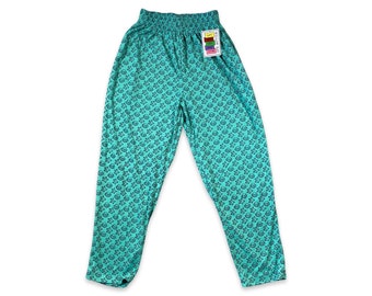 May include: Teal blue pants with a black star pattern. The pants have an elastic waistband and a tag that says "Easy Fit" on it.