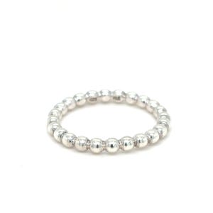 May include: A silver ring featuring a continuous band of small, evenly spaced, spherical beads. The ring is set against a plain white background, highlighting its polished, reflective surface. This piece of jewelry is a simple yet elegant accessory.