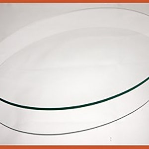 May include: A clear glass oval tabletop with a beveled edge.