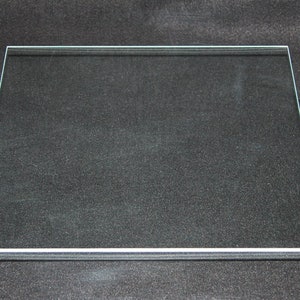 May include: A clear glass square tabletop with beveled edges.
