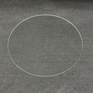 May include: A set of three ceramic mugs with a speckled, matte finish. The mugs are in shades of cream, light gray, and dark gray. Each mug has a simple, minimalist design and a rounded handle. The mugs are likely for coffee or tea.