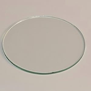 May include: A clear glass circle, approximately 4 inches in diameter.