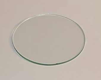 May include: A clear glass circle, approximately 4 inches in diameter.
