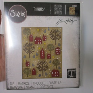 May include: A Sizzix Thinlits die set featuring a winter village design with houses, trees, and birds. The die set is packaged in a clear plastic sleeve with a white background and the text "THINLITS" and "Sizzix" printed in black. The die set is designed by Jim Holtz and has the number 665558 printed on the package. The die set is for use with a die-cutting machine.