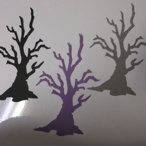 Pode incluir: Tr&ecirc;s recortes de papel de &aacute;rvores nuas em preto, cinza e roxo. As &aacute;rvores t&ecirc;m todas a mesma forma, mas tamanhos diferentes. Todas est&atilde;o sobre um fundo branco.