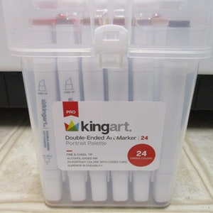 May include: A clear plastic case containing 24 double-ended alcohol-based art markers. The case has a label that reads "kingart. PRO Double-Ended Art Marker | 24 Portrait Palette" and "FINE & CHISEL TIP ALCOHOL-BASED INK 24 PORTRAIT COLORS WITH CODED CAPS SUPERIOR BLENDABILITY 24 UNIQUE COLORS".