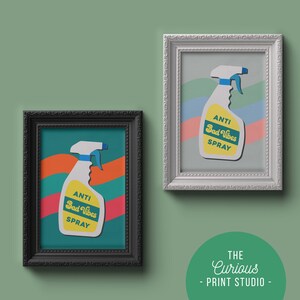 May include: Two framed prints of a yellow and white spray bottle with the text "Anti Bad Vibes Spray" in a retro font. The prints are in black and white frames and are on a green background.