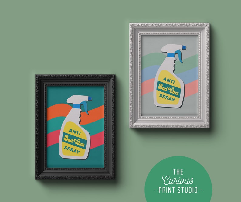 May include: Two framed prints of a yellow and white spray bottle with the text "Anti Bad Vibes Spray" in a retro font. The prints are in black and white frames and are on a green background.