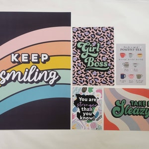 May include: Five colorful prints with motivational quotes. The prints feature a rainbow, a leopard print, a cup of tea, a colorful abstract design, and a rainbow with the words "Take It Sleazy".